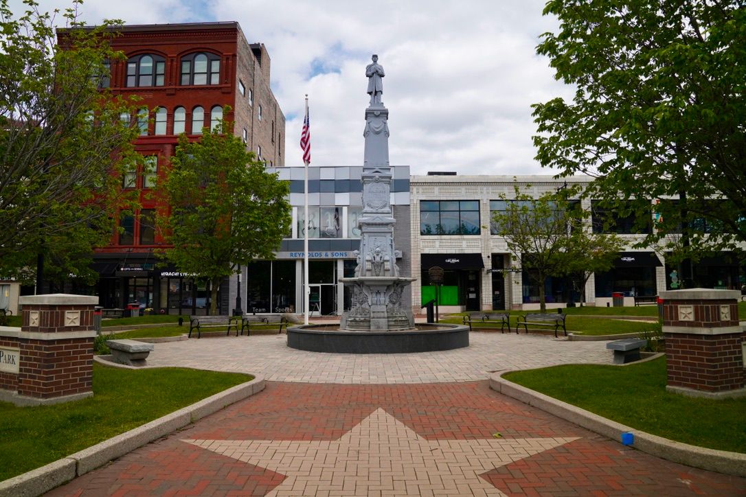 A park with a monument and a brick star in the pavement